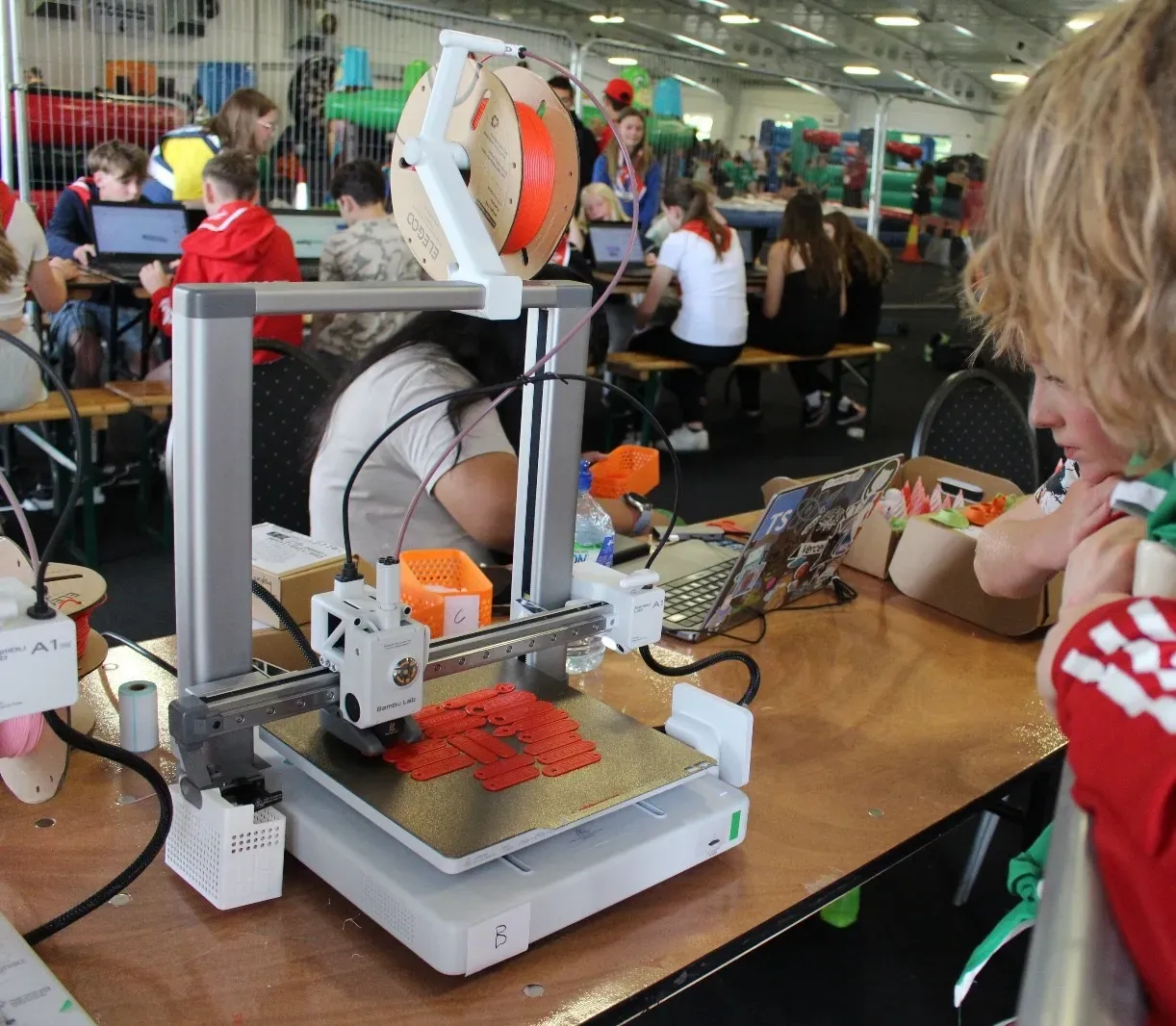 A 3D printer part way through a print at a workshop.