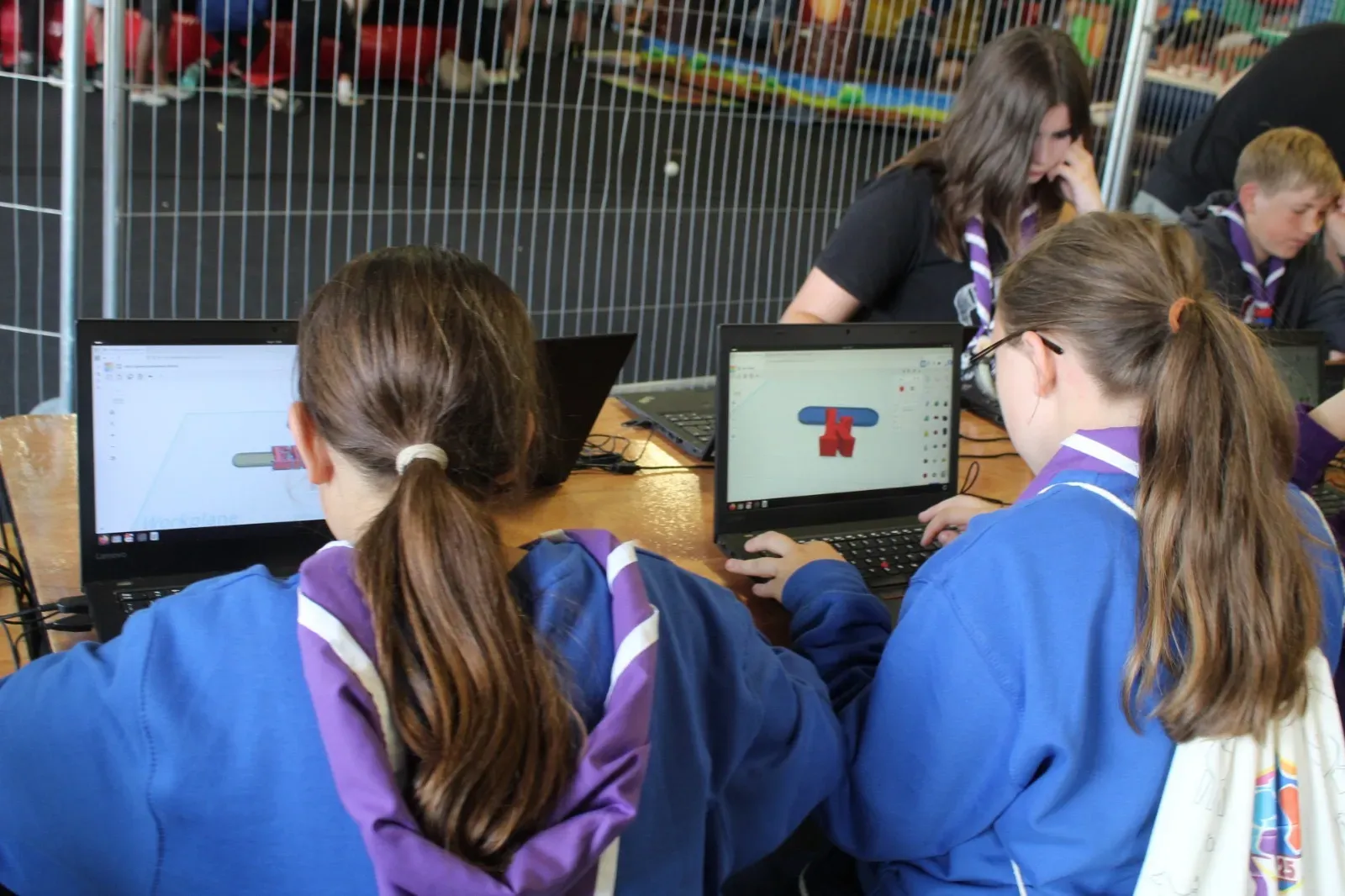 A young person modelling a design on screen in Tinkercad.